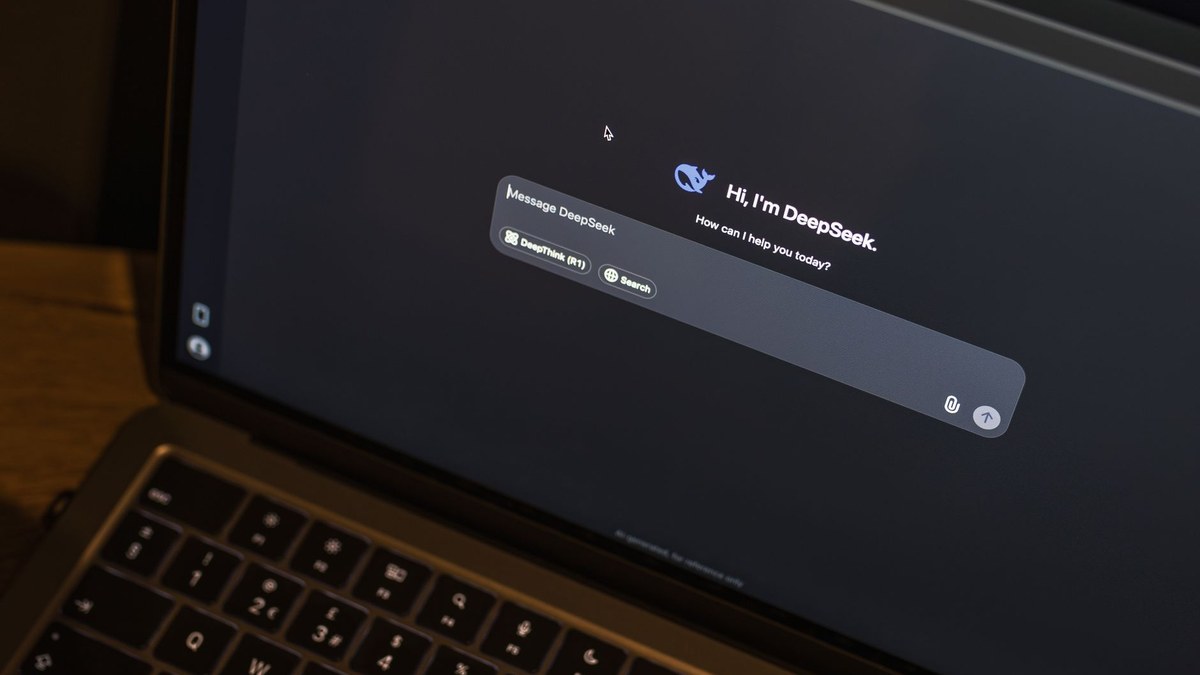 A laptop screen displaying the DeepSeek AI chatbot interface with a message input box on a dark background.